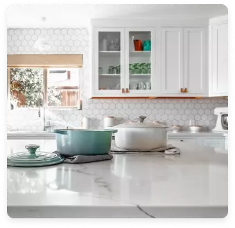 A kitchen backsplash with a unique and creative design. The backsplash is made of a variety of tiles, including hexagonal tiles, subway tiles, and mosaic tiles. The tiles are arranged in a geometric pattern that creates a visually stunning effect.